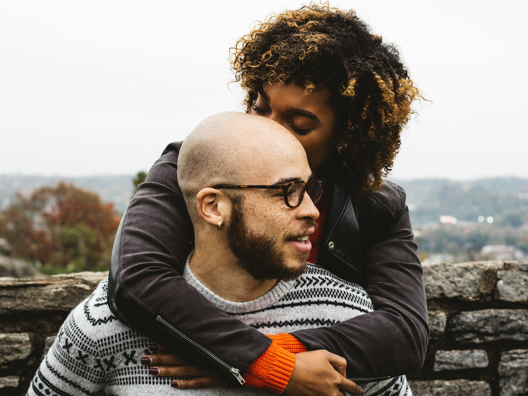 woman kissing man's head
