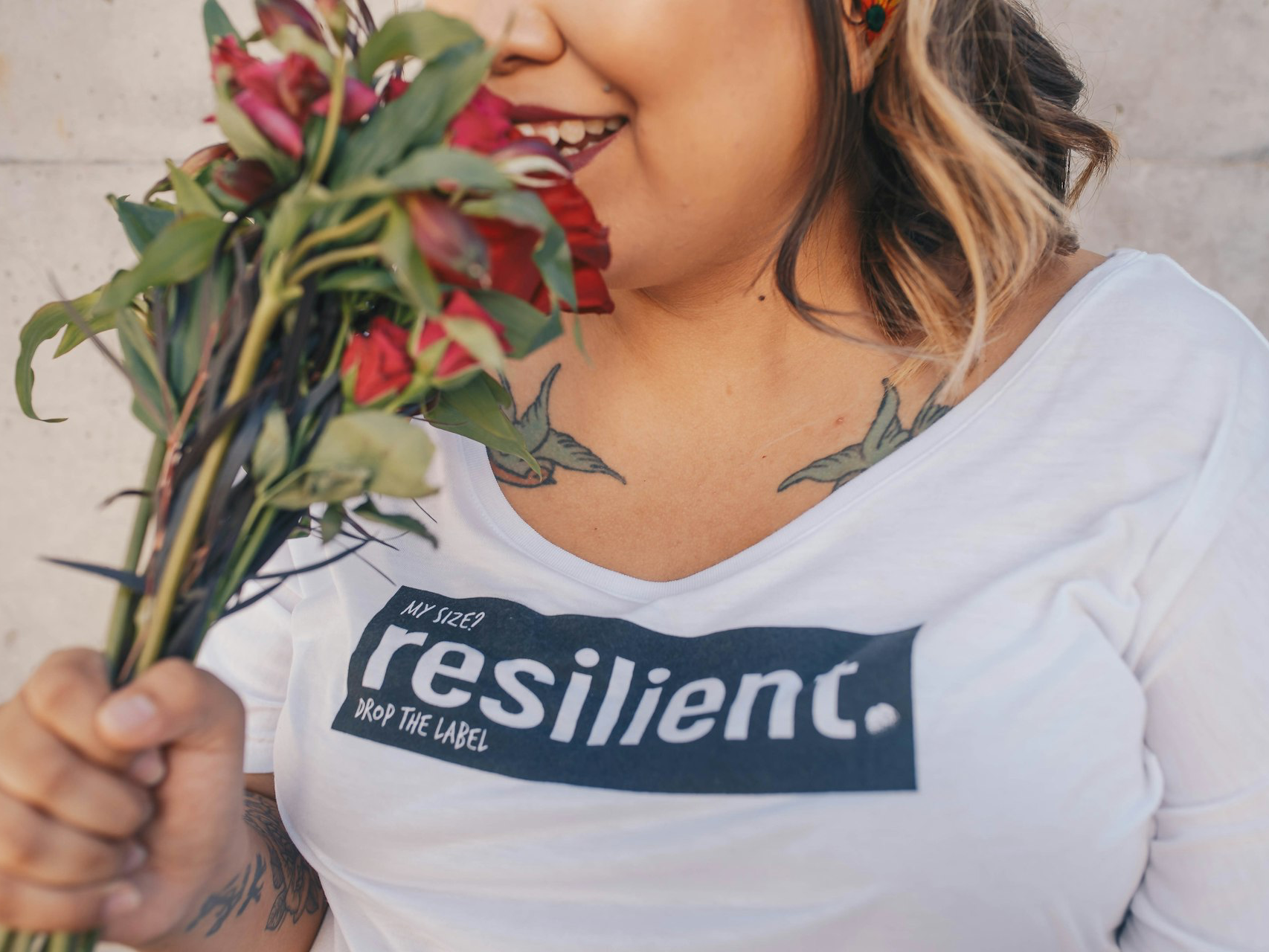 woman smelling red roses